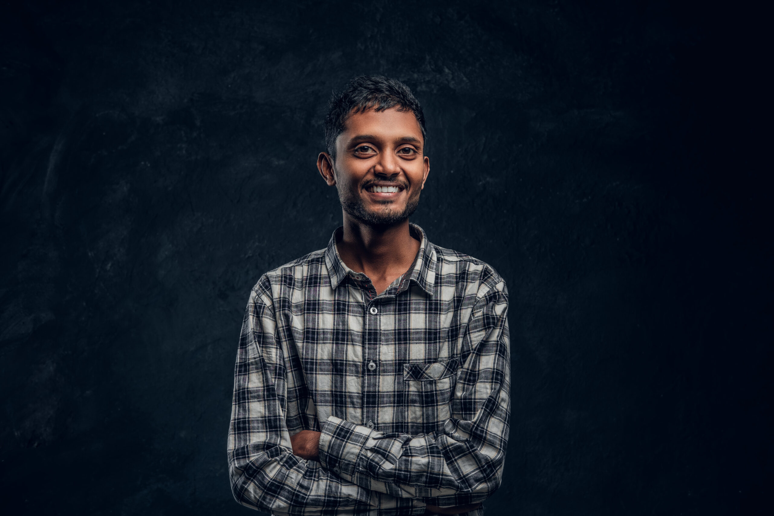 Home cheerful hindu guy posing and laughing