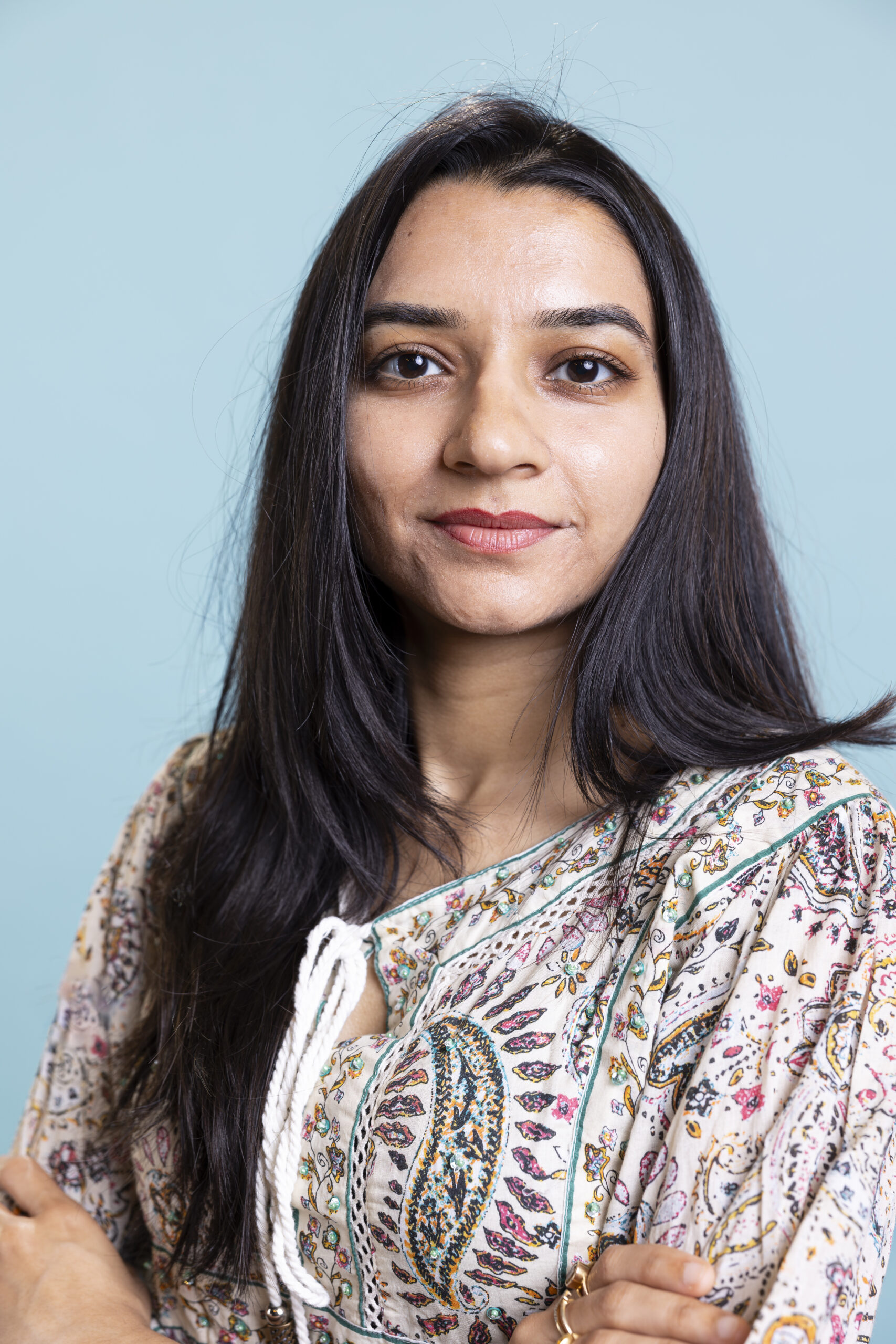Home indian woman posing in a cute stylish outfit on camera and smiling